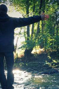 Young woman with closed eyes experiencing harmony with nature