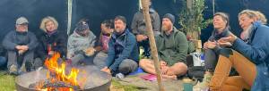 Eine Naturselbsterfahrung-Gruppe schaut ins Lagerfeuer